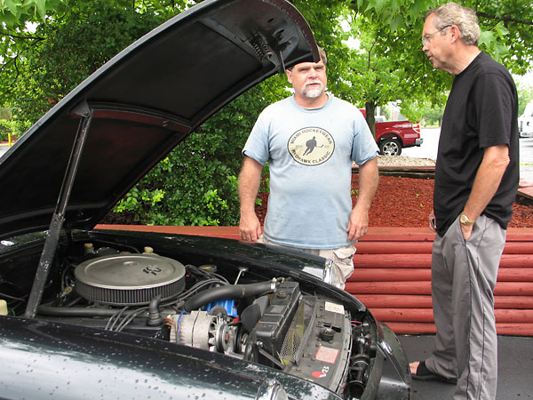Dennis Williams shows his Rover 3.9 powered MGB to Terry Schulte.