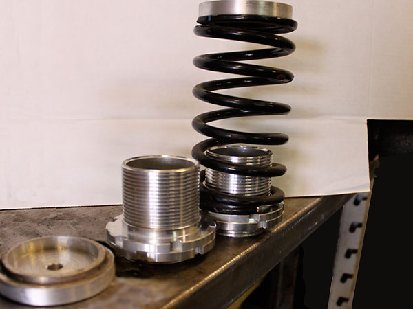 Smaller, lighter coilover-style springs and threaded perchs to facilitate fine-tuning ride height.