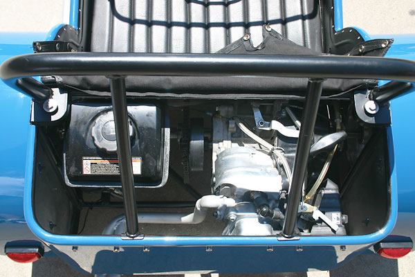 A solid axle on pillow block bearings is connected to the engine via chain and sprockets.