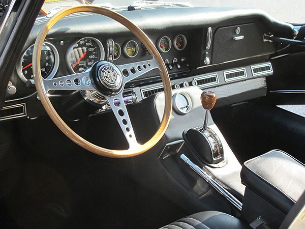 1967 Jaguar XKE dashboard, with well integrated air conditioning duct, vents, and controls.
